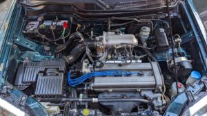 A clean engine bay of an older suv that has recently been detailed. 