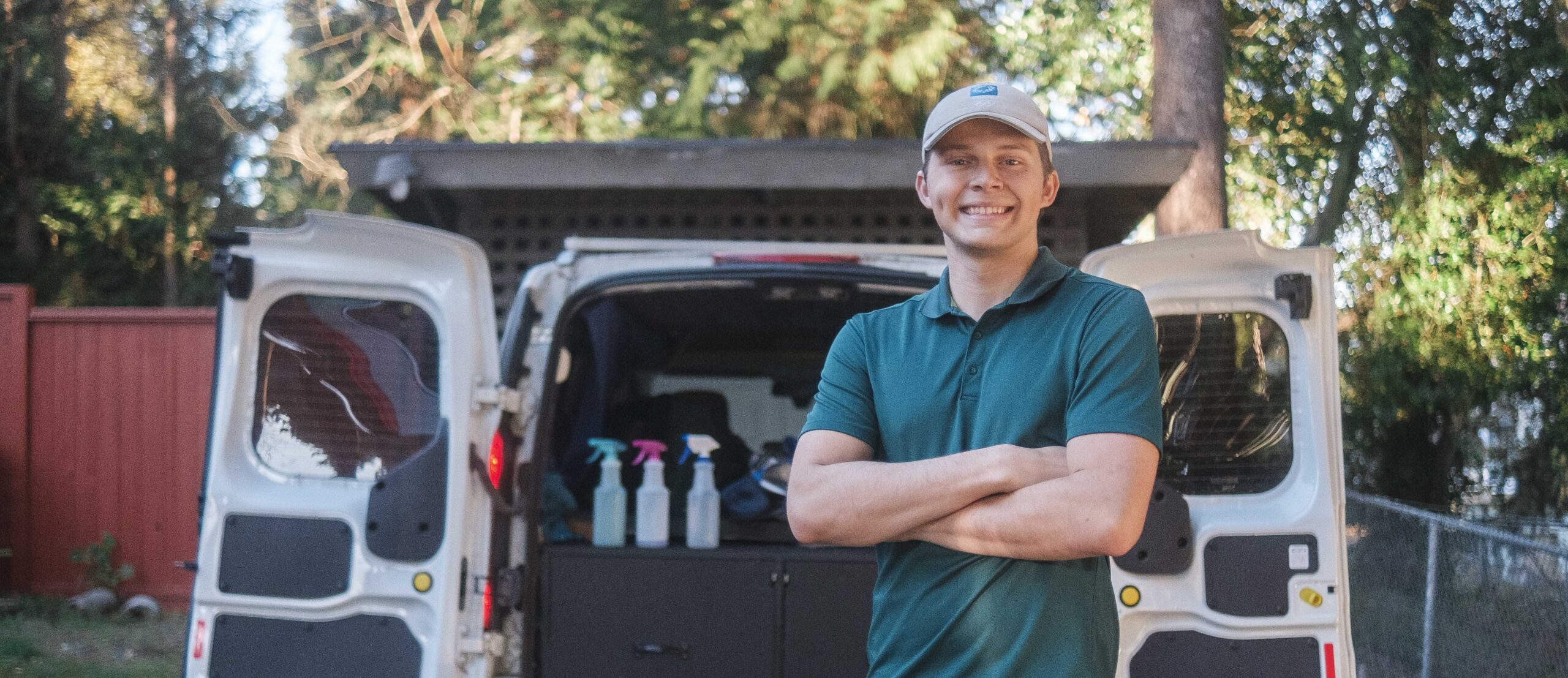 Smiling detailer stands in front of his mobile detailing van in North Seattle.